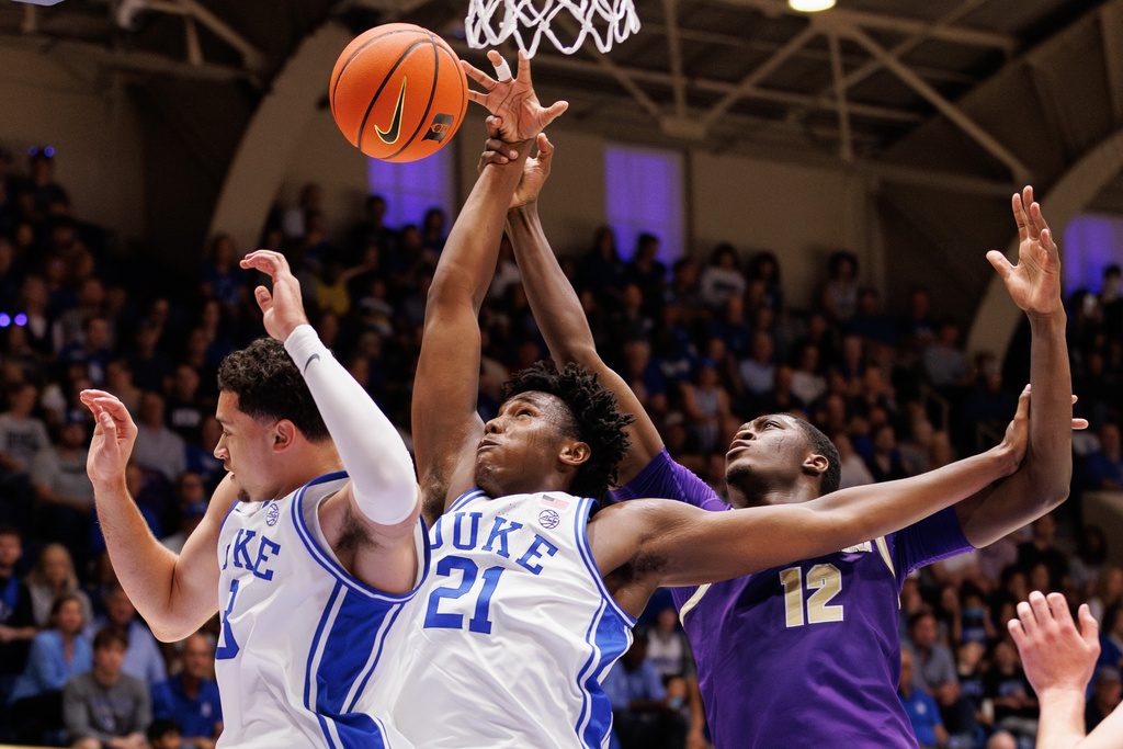 Duke's Patrick Ngongba II (21) and Darren Harris (8) battle for a rebound with Western Carolina's Samuel Dada (12) during the first half of an NCAA college basketball game in Durham, N.C., Saturday, Nov. 8, 2025. (AP Photo/Ben McKeown)
