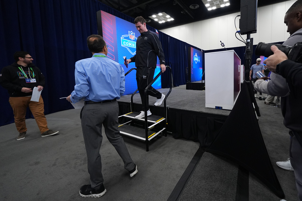 Indiana quarterback Fernando Mendoza leaves after speaking during a news conference at the NFL football scouting combine in Indianapolis, Friday, Feb. 27, 2026. (AP Photo/Julio Cortez)