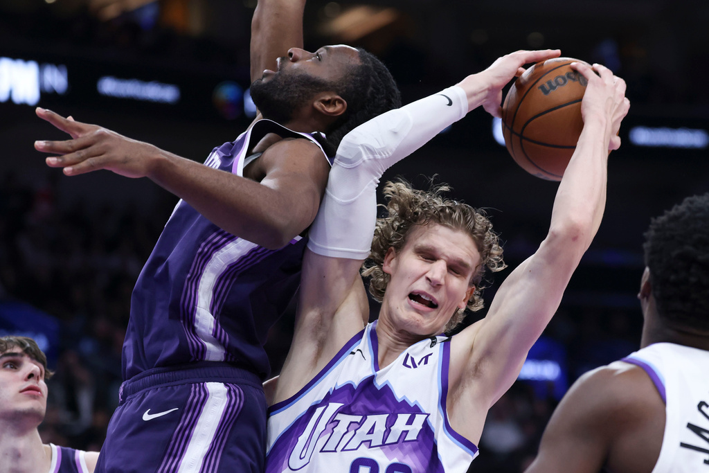 Sacramento Kings forward Precious Achiuwa, left, and Utah Jazz forward Lauri Markkanen battle for a rebound during the first half of an NBA basketball game, Wednesday, Feb. 11, 2026, in Salt Lake City. (AP Photo/Rob Gray)