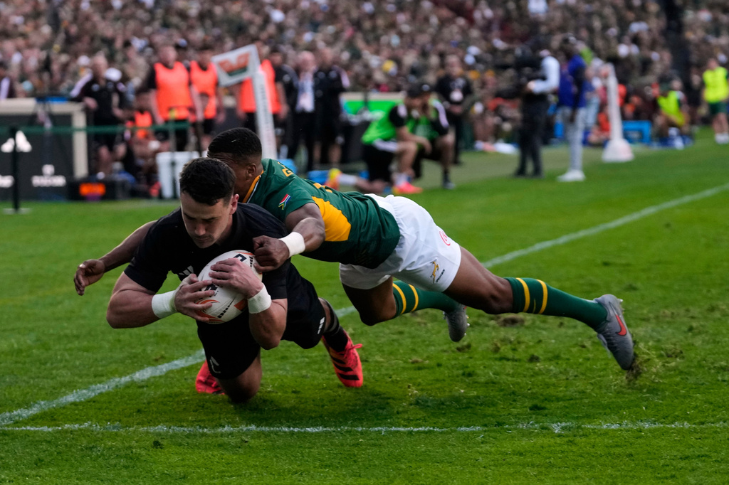 New Zealand's Will Jordan, front, scores a try as South Africa's Grant Williams tries to defend during a Test rugby match between South Africa and New Zealand, in Johannesburg, South Africa, Saturday, Aug. 22, 2026. (AP Photo/Themba Hadebe)