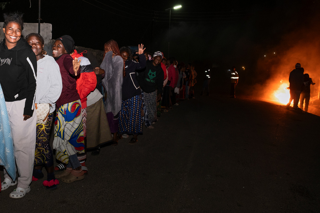 Zambians queue outside a polling station on the outskirts of Lusaka, Zambia, Thursday, Aug. 13, 2026. (AP Photo/Anita Reed)