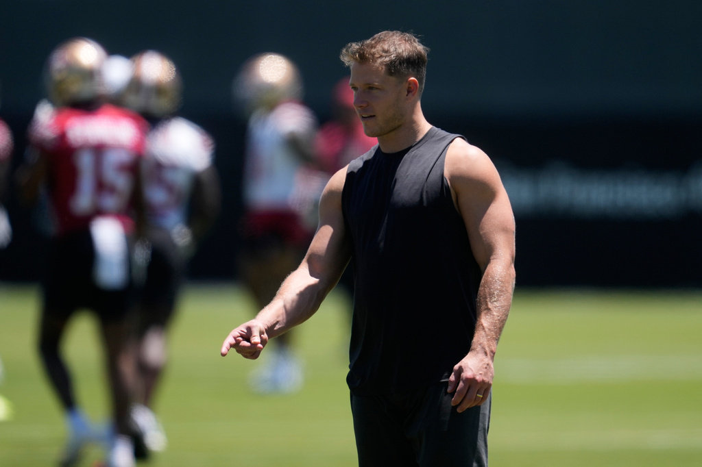 San Francisco 49ers running back Christian McCaffrey gestures on the field during NFL football practice Wednesday, June 3, 2026, in Santa Clara, Calif. (AP Photo/Jeff Chiu)