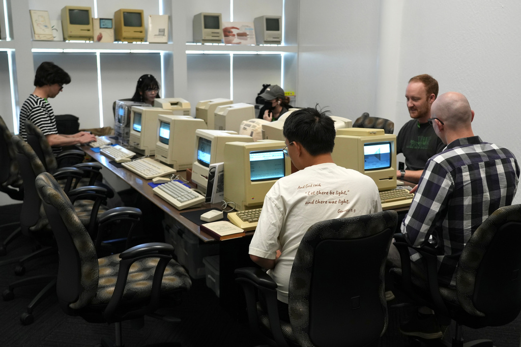 Attendees play on Apple Macintosh computers from the 1980s at the Vintage Computer Festival in Mountain View, Calif., Sunday, Aug. 2, 2026. (AP Photo/Terry Chea)
