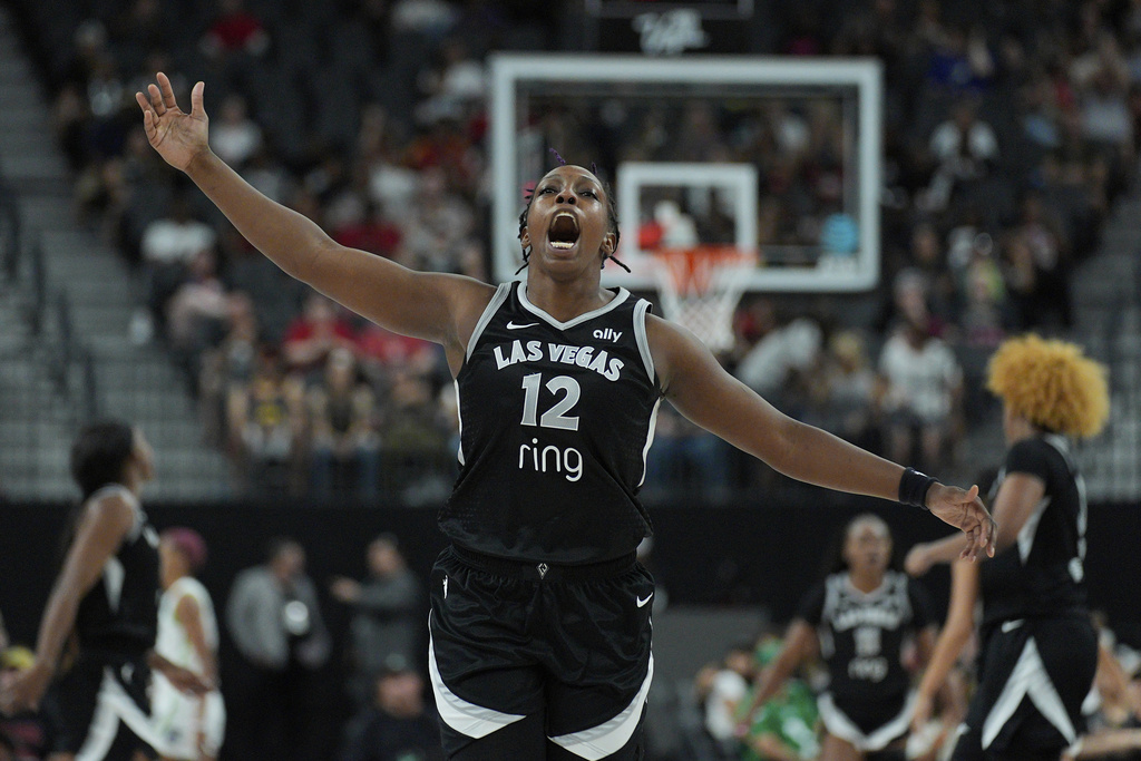 Las Vegas Aces guard Chelsea Gray (12) celebrates after a play against the Minnesota Lynx during the second half of a WNBA basketball game Thursday, Sept. 4, 2025, in Las Vegas. (AP Photo/John Locher)