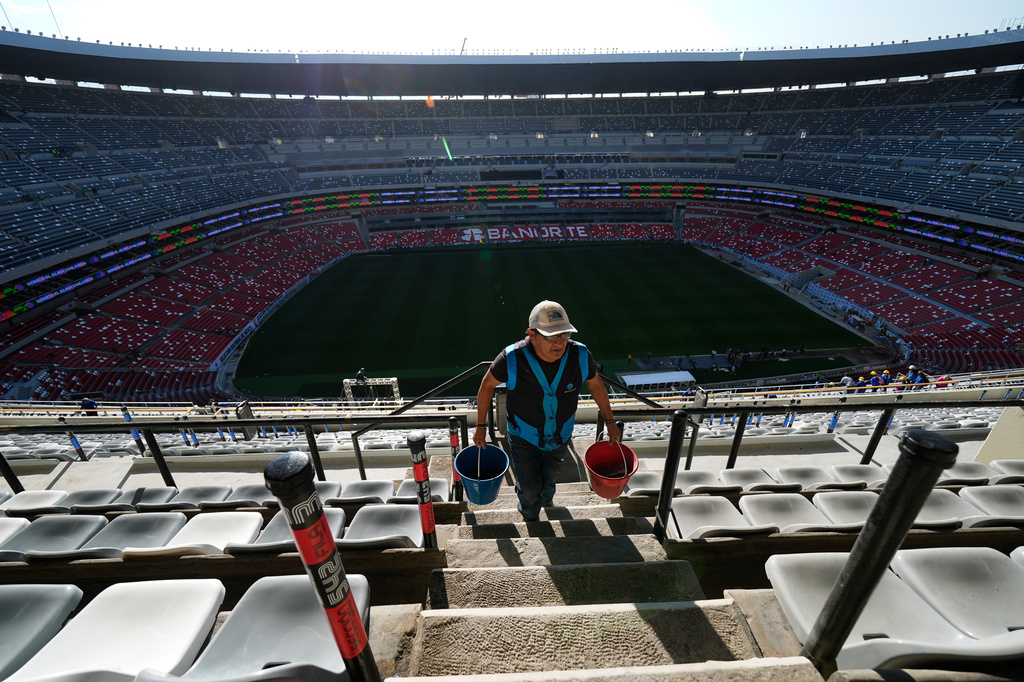 A worker carries buckets at the Azteca Stadium during a press tour showcasing renovations ahead of the 2026 World Cup, in Mexico City, Thursday, March 26, 2026. (AP Photo/Marco Ugarte)