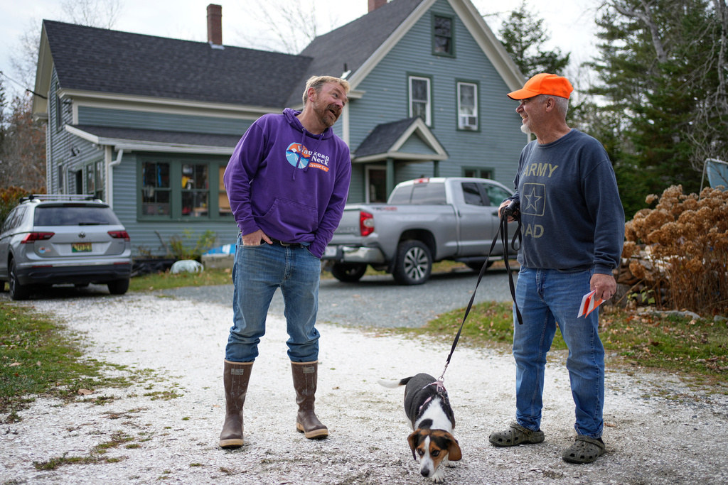 Graham Platner, Democratic candidate for U.S. Senate, chats with his neighbor, Denis Nault, Monday, Nov. 3, 2025, in Sullivan, Maine. (AP Photo/Robert F. Bukaty)