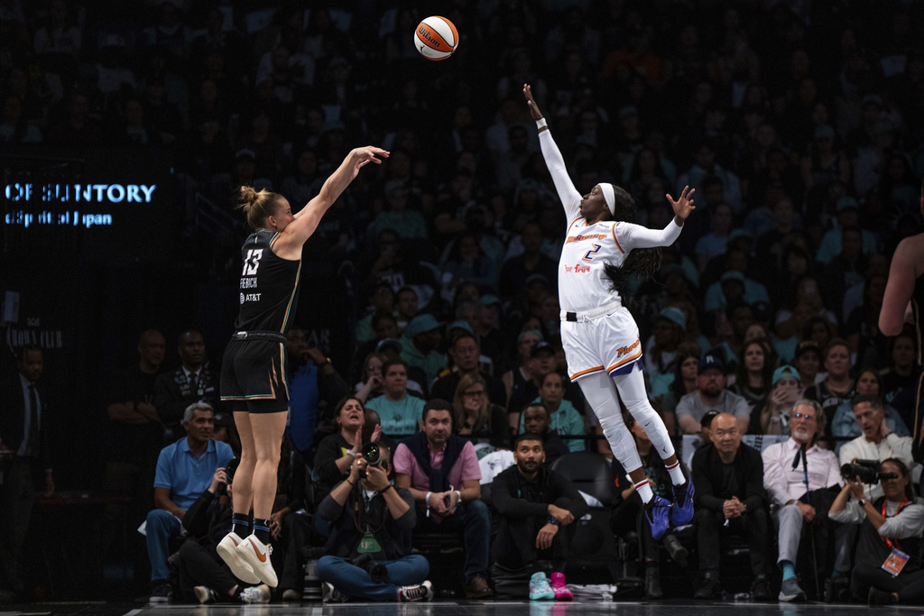 New York Liberty forward Leonie Fiebich (13), guarded by Phoenix Mercury guard Kahleah Copper (2), shoots a three-pointer during Game 2 in the first round of the WNBA basketball playoffs, Wednesday, Sept. 17, 2025, in New York. (AP Photo/Angelina Katsanis)