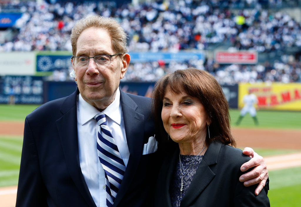 FILE - New York Yankees broadcasters John Sterling and Suzyn Waldman pose during a retirement ceremony for Sterling before a baseball game against the Tampa Bay Rays at Yankee Stadium in New York, April 20, 2024. (AP Photo/Noah K. Murray, file)