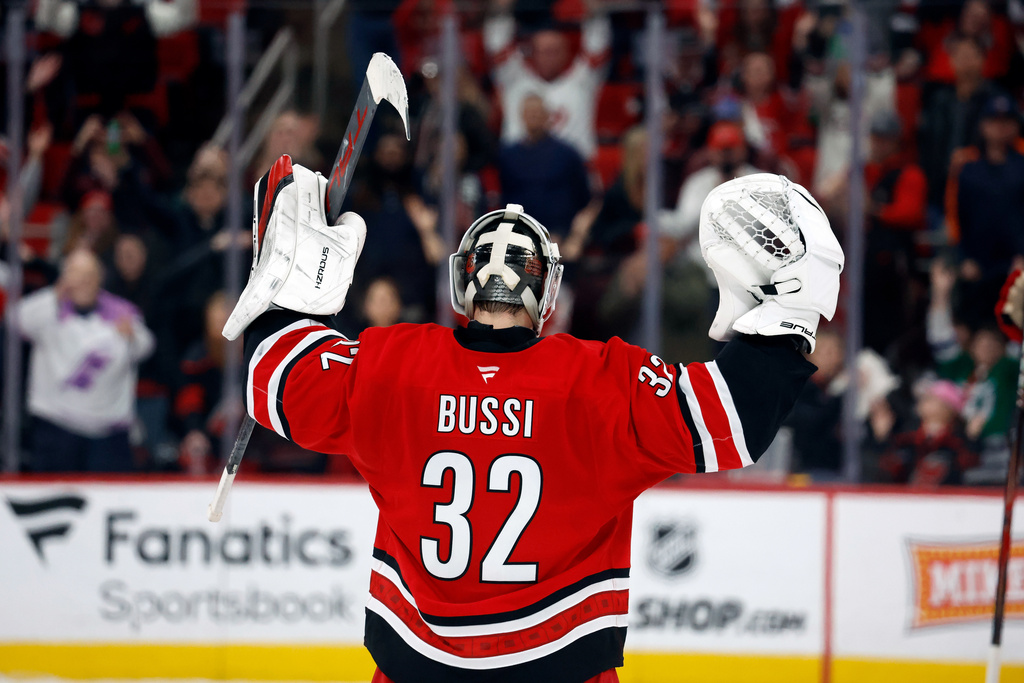 Carolina Hurricanes goaltender Brandon Bussi (32) celebrates during a "Storm Surge" celebration following an NHL hockey game against the Florida Panthers in Raleigh, N.C., Friday, Jan. 16, 2026. (AP Photo/Karl DeBlaker)