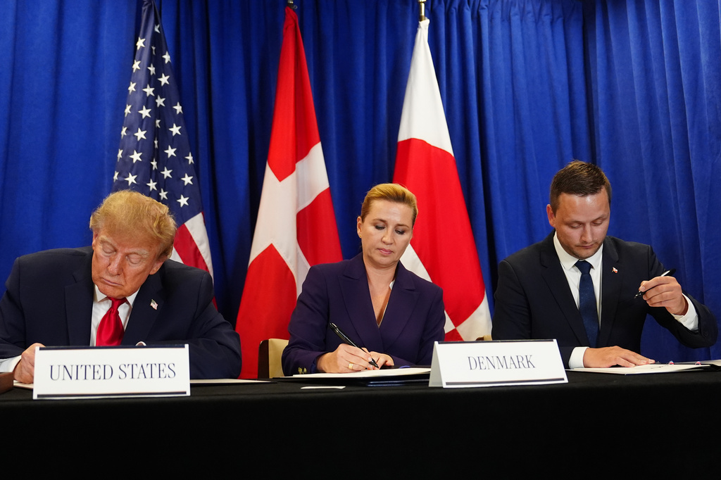 President Donald Trump signs a security agreement with Denmark's Prime Minister Mette Frederiksen and Greenland's Prime Minister Jens-Frederik Nielsen during the United Nations General Assembly, Tuesday, Sept. 22, 2026, at the UN headquarters. (AP Photo/Julia Demaree Nikhinson)
