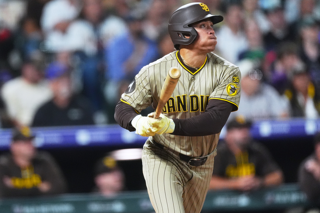 San Diego Padres' Dustin Harris breaks from the batter's box after connecting for an RBI triple off Colorado Rockies starting pitcher Mason Adams in the fourth inning of a baseball game Wednesday, Sept. 16, 2026, in Denver. (AP Photo/David Zalubowski)