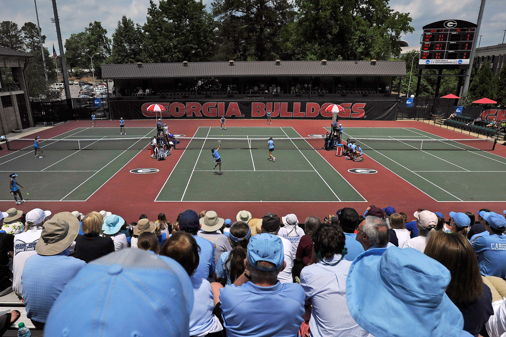 FILE - Spectators crowd center court at the Dan Magill Tennis Complex during the UCLA and North Carolina women's doubles match in the NCAA Division I tennis championships, May 20, 2014, in Athens, Ga. (AP Photo/David Tulis, File)
