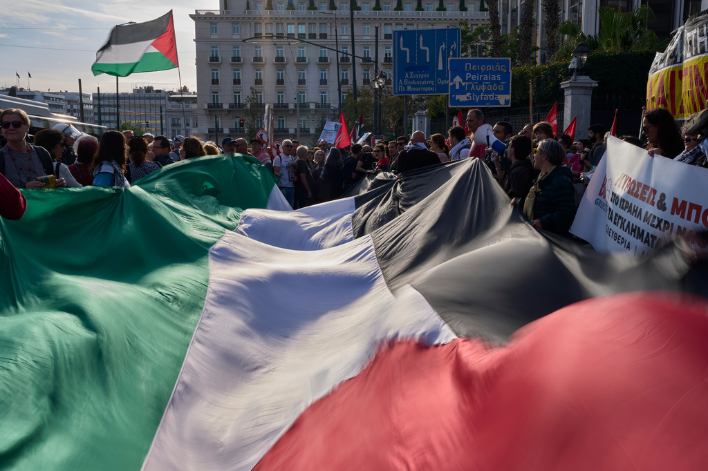 Demonstrators wave a giant Palestinian flag outside Greece's Foreign Ministry in Athens, Thursday, April 30, 2026, during a rally to protest the interception of Gaza aid ships by Israeli forces near Greek waters. (AP Photo/Petros Giannakouris)