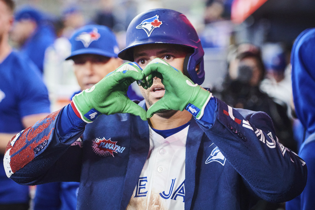 Toronto Blue Jays' George Springer (4) celebrates in the dugout after hitting a solo home run against the Minnesota Twins during fifth inning MLB baseball action in Toronto, on Tuesday, Aug. 26, 2025. (Sammy Kogan/The Canadian Press via AP)