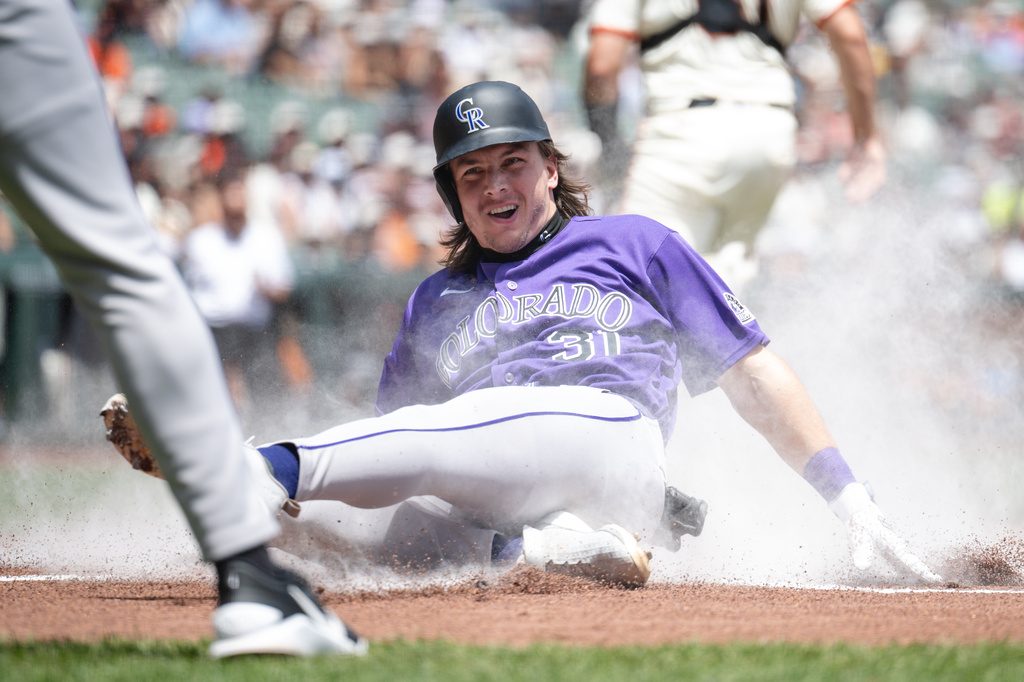 Colorado Rockies' Jake McCarthy slides into home plate to score during the first inning of a baseball game against the San Francisco Giants, Sunday, July 12, 2026, in San Francisco. (AP Photo/Thien-An Truong)
