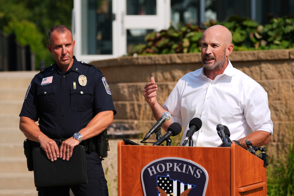 Hopkins Mayor Patrick Hanlon, flanked by Police Chief Brent Johnson, speaks at a news conference in Hopkins, Minn., Wednesday, Aug. 12, 2026, where police said a man who killed his wife and their 7-year-old daughter at an in-home daycare is also suspected of killing a 78-year-old female relative. (AP Photo/Ellen Schmidt)