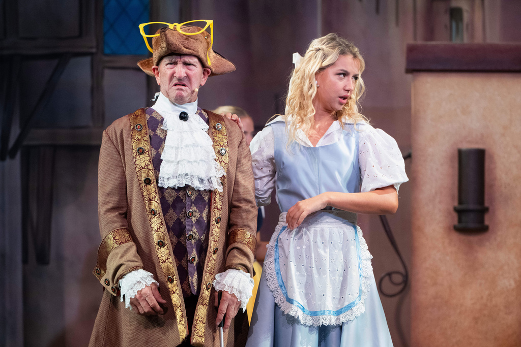 Michael Edwards, better known as Eddie the Eagle, plays Professor Crackpot, as he performs with fellow actors in the pantomime "Beauty and the Beast" at Watersmeet Theatre, in Rickmansworth, England, Dec. 5, 2025. (AP Photo/Thomas Krych)