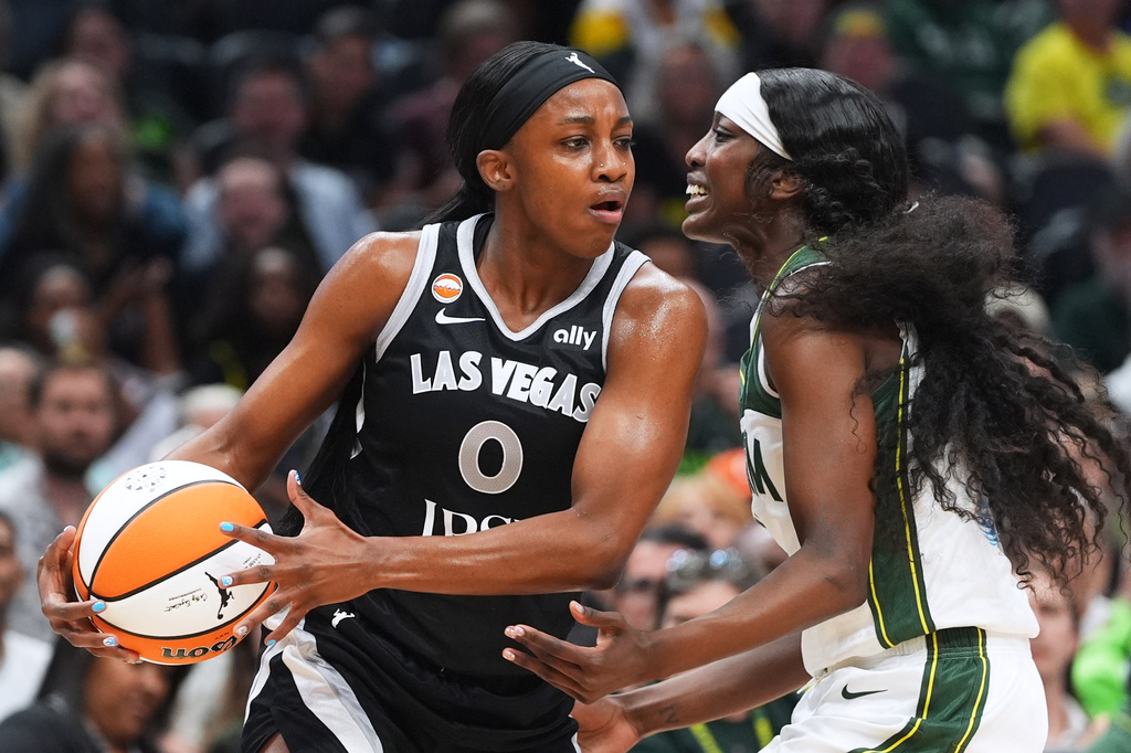 Las Vegas Aces guard Jackie Young, left, looks around the defense of Seattle Storm guard Flau'jae Johnson, right, during the first half of a WNBA basketball game, Thursday, Sept. 17, 2026, in Seattle. (AP Photo/Lindsey Wasson)