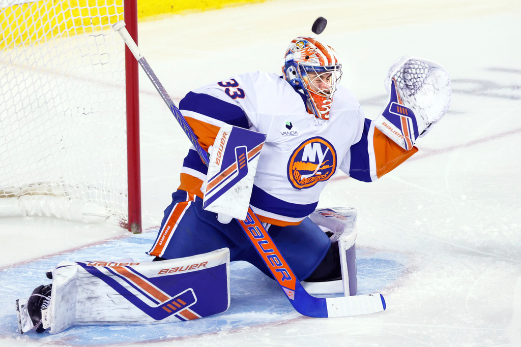 New York Islanders goalie David Rittich makes a save on a Calgary Flames shot during third period NHL hockey action in Calgary, Ab., Saturday, Jan. 17, 2026. (Larry MacDougal/The Canadian Press via AP)