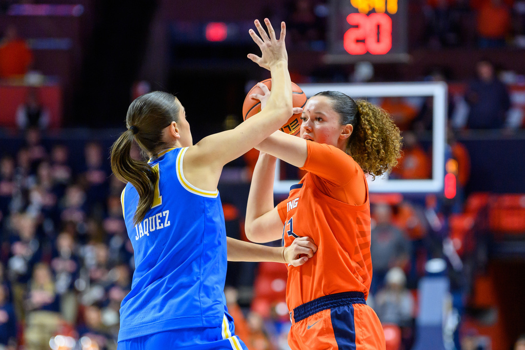 Illinois' Berry Wallace looks for an outlet as UCLA's Gabriela Jaques defends during the first half of an NCAA college basketball game Wednesday, Jan. 28, 2026, in Champaign, Ill. (AP Photo/Craig Pessman)