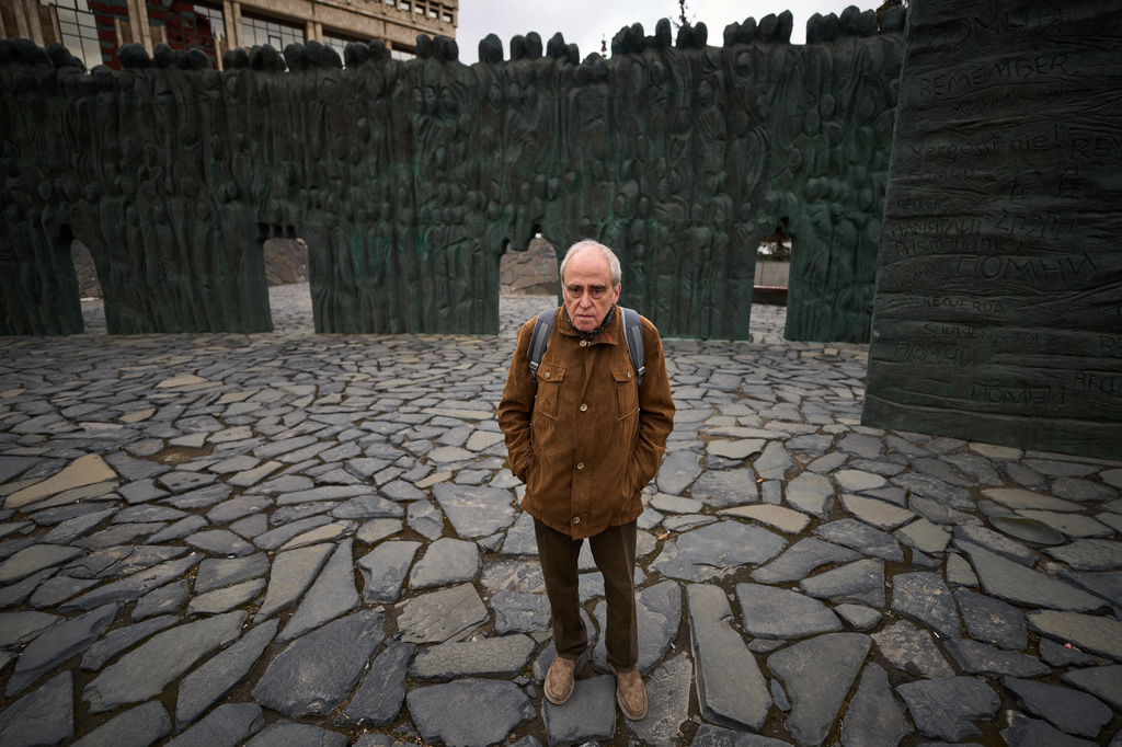 Jan Raczynski, chair of the International Memorial entity that was liquidated in Russia in 2021, stands after his interview with the Associated Press in front of the Wall of Grief memorial to the victims of Soviet repressions in Moscow, Wednesday, April 8, 2026. (AP Photo/Alexander Zemlianichenko)