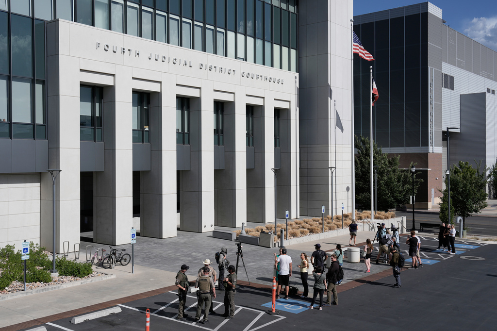People stand outside the Fourth District Courthouse, Tuesday, July 7, 2026, in Provo, Utah, after a hearing for Tyler Robinson, accused in the fatal shooting of Charlie Kirk. (AP Photo/Spenser Heaps)