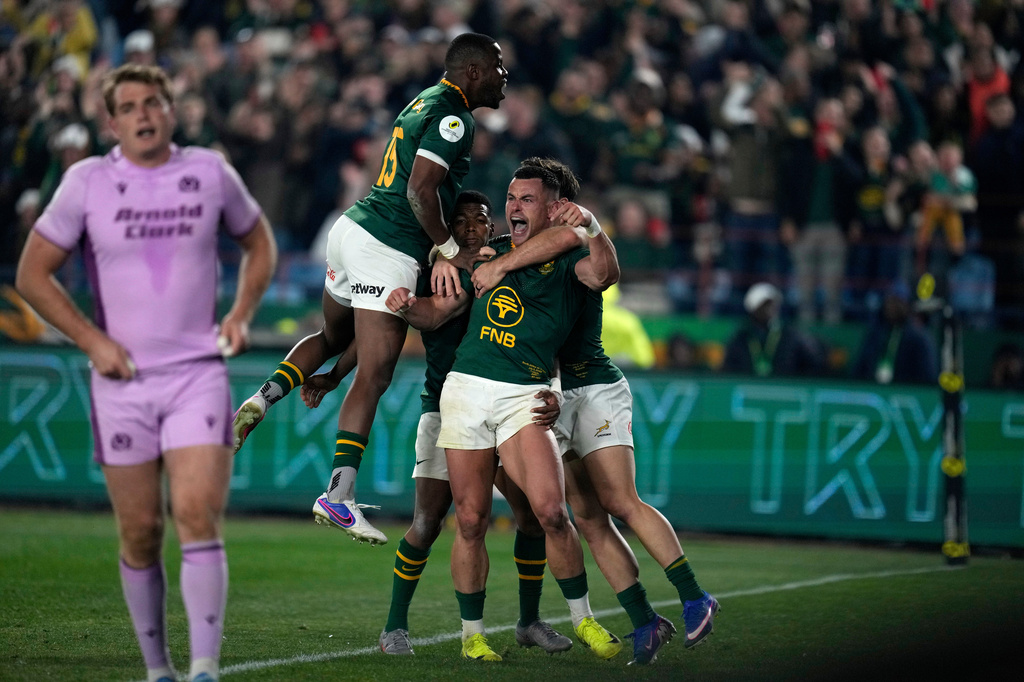 South Africa's Jesse Kriel, center, celebrates with his teammates after scoring a try during the Nations Championship Test rugby match between South Africa and Scotland, in Pretoria, Saturday, July 11, 2026. (AP Photo/Themba Hadebe)