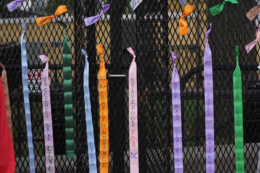 Protest ribbons are tied to a fence at Lafayette Park, near the White House, Tuesday, Aug. 25, 2026, in Washington. (AP Photo/Alex Brandon)