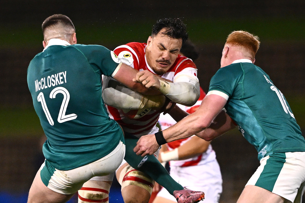 Ben Gunter, center, of Japan is tackled by Ireland's Stuart McCloskey, left, and Ciaran Frawley during the Nations Championship rugby international between Japan and Ireland in Newcastle, Australia, Saturday, July 11, 2026. (Dan Himbrechts/AAPImage via AP)