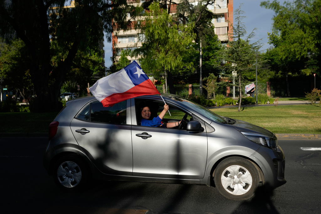 Supporters of Jose Antonio Kast, presidential candidate of the opposition Republican Party, celebrate preliminary results after polls closed for a presidential runoff election in Santiago, Chile, Sunday, Dec. 14, 2025. (AP Photo/Matias Delacroix)