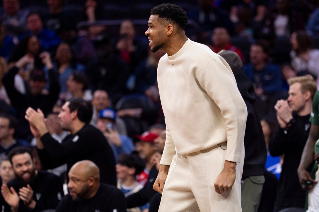 Milwaukee Bucks power forward Giannis Antetokounmpo, center, reacts from the sideline during the first half of an NBA basketball game against the Philadelphia 76ers, Sunday, April 12, 2026, in Philadelphia. (AP Photo/Chris Szagola)