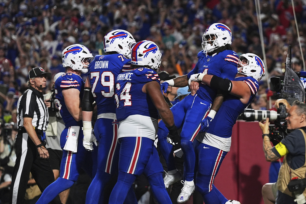 Buffalo Bills running back James Cook, second from right, celebrates with teammates after scoring a touchdown during the second half of an NFL football game against the Miami Dolphins, Thursday, Sept. 18, 2025, in Orchard Park, N.Y. (AP Photo/Matt Rourke)