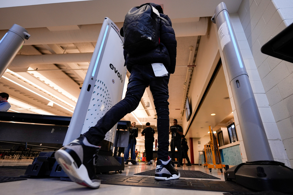 A student walks through security at Midtown High School, Friday, March 6, 2026, in Atlanta. (AP Photo/Mike Stewart)