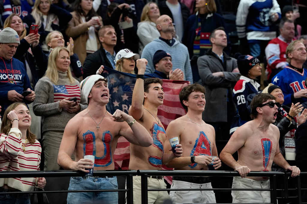 United States fans cheer during a preliminary round match of men's ice hockey between United States and Denmark at the 2026 Winter Olympics, in Milan, Italy, Saturday, Feb. 14, 2026. (AP Photo/Petr David Josek)