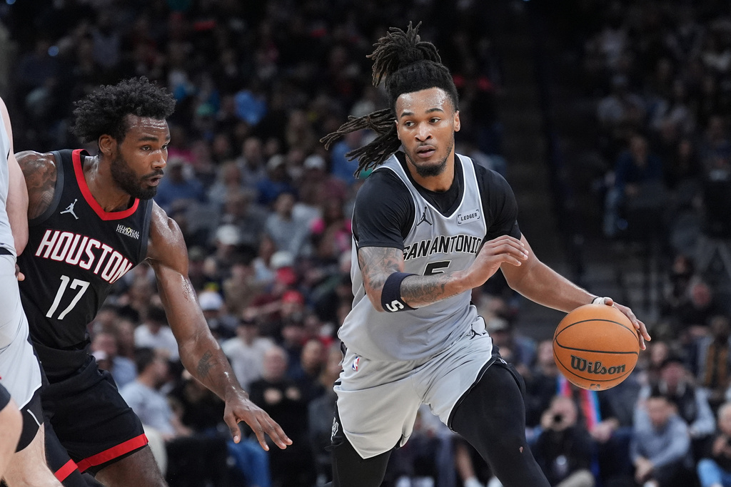 San Antonio Spurs guard Stephon Castle (5) drives around Houston Rockets forward Tari Eason (17) during the first half of an NBA basketball game in San Antonio, Sunday, March 8, 2026. (AP Photo/Eric Gay)
