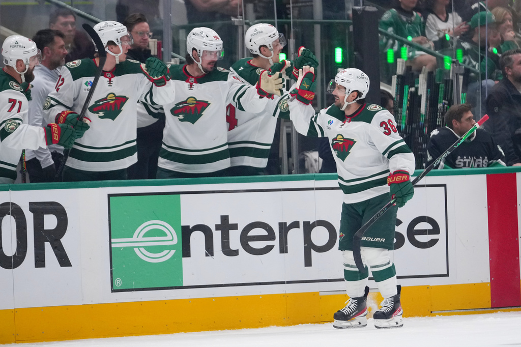 Minnesota Wild right wing Mats Zuccarello skates by his bench after scoring a goal against the Dallas Stars during the first period in Game 5 of a first-round NHL Stanley Cup playoffs hockey series, Tuesday, April 28, 2026, in Dallas. (AP Photo/Julio Cortez)