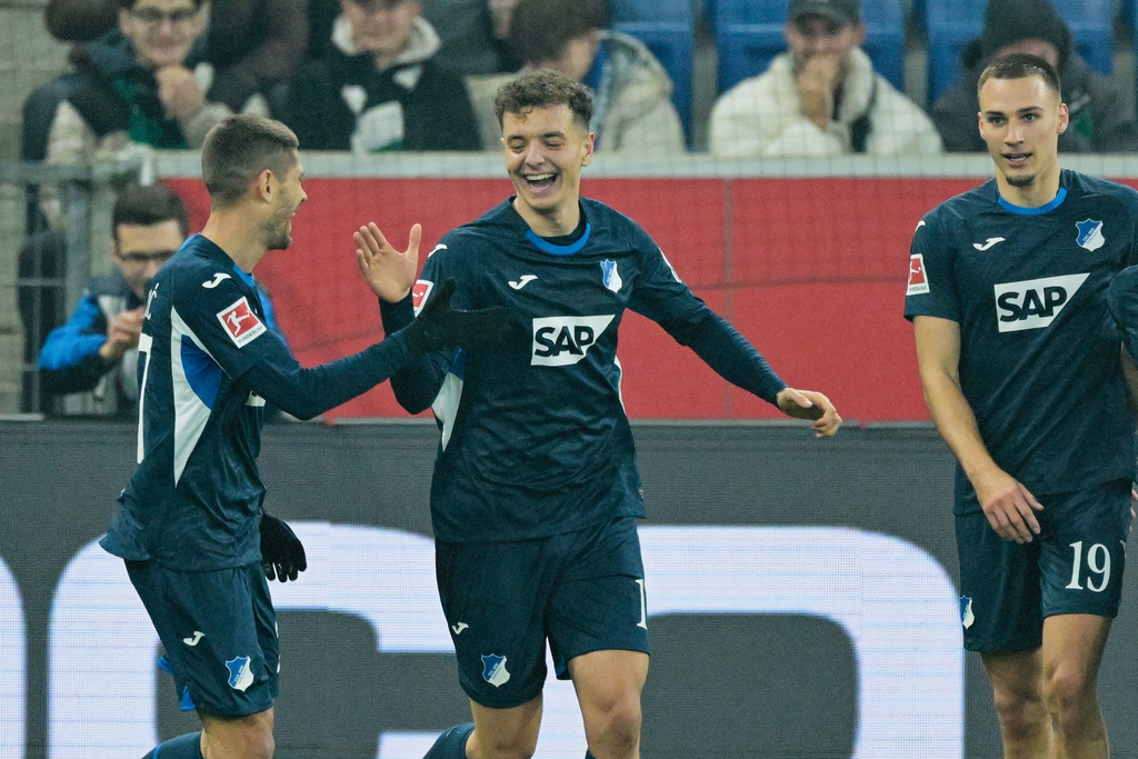 Hoffenheim's Tim Lemperle, center, celebrates scoring during the Bundesliga soccer match between TSG 1899 Hoffenheim and Bor. Mönchengladbach in Sinsheim, Germany, Wednesday Jan. 14, 2026. (Uwe Anspach/dpa via AP)