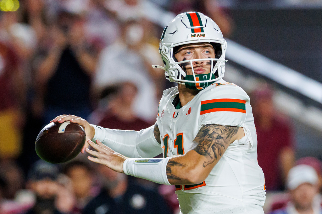 Miami quarterback Carson Beck (11) looks for a receiver during the first half of an NCAA college football game against Florida State, Saturday, Oct. 4, 2025, in Tallahassee, Fla. (AP Photo/Colin Hackley)