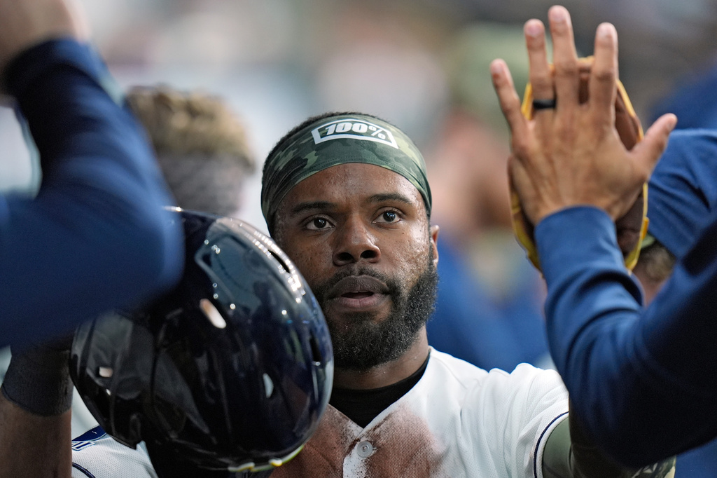 Tampa Bay Rays' Cedric Mullins celebrates in the dugout after scoring on a fielder's choice by Taylor Walls off Miami Marlins pitcher Janson Junk during the second inning of a baseball game Friday, May 15, 2026, in St. Petersburg, Fla. (AP Photo/Chris O'Meara)