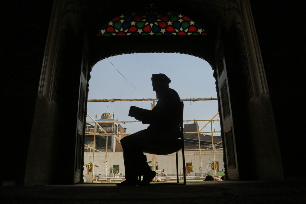 A Muslim recites the Quran during the Muslim holy fasting month of Ramadan, at a mosque in Peshawar, Pakistan, Thursday, Feb. 19, 2026. (AP Photo/Muhammad Sajjad)