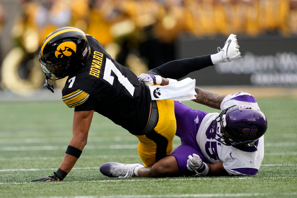 Iowa wide receiver Dayton Howard (7) is tackled by Northern Iowa safety Anthony Isley (35) after catching a pass during the first half of an NCAA college football game in Iowa City, Iowa, Saturday, Sept. 19, 2026. (AP Photo/Charlie Neibergall)