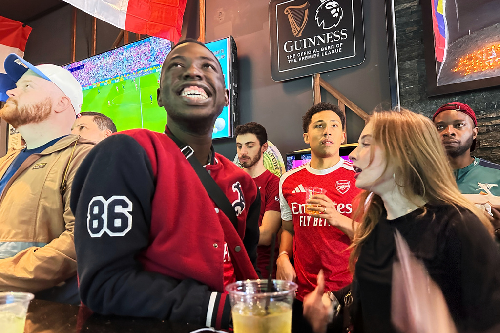 Fans watch a Champion league soccer match between Arsenal and Paris Saint-Germain at the Lion Sports Bar, Saturday, May 30, 2026, in Philadelphia. (AP Photo/Tassanee Vejpongsa)