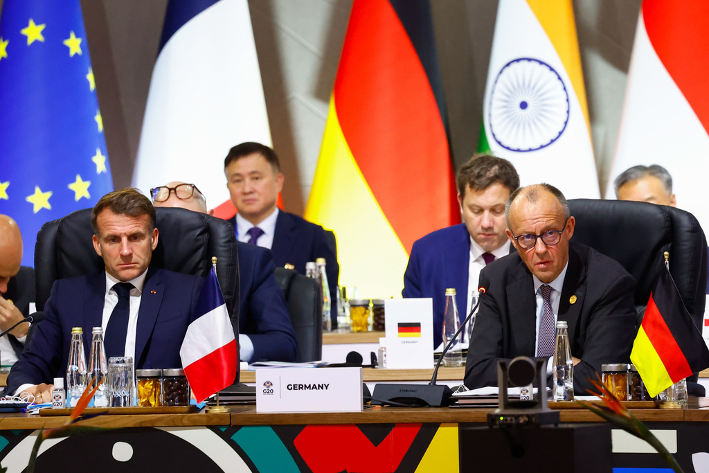 France's President Emmanuel Macron and Germany's Chancellor Friedrich Merz attend a plenary session on the opening day of the G20 Summit at the Nasrec Expo Centre, in Johannesburg, South Africa, Saturday, Nov. 22, 2025. (Thomas Mukoya/Pool Photo via AP)