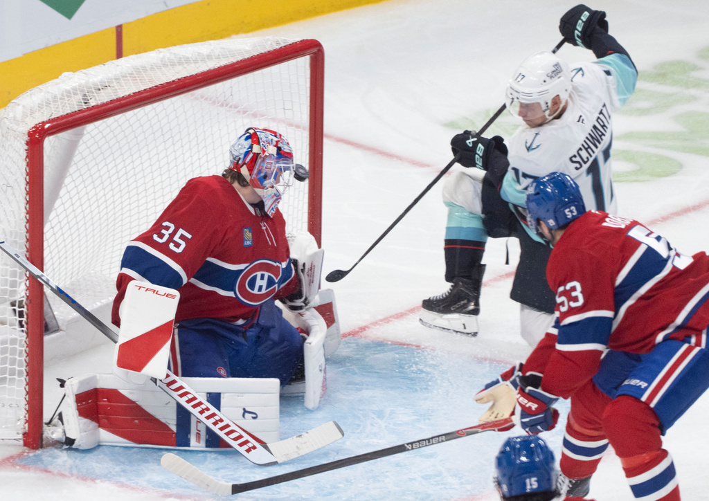 Seattle Kraken' Jaden Schwartz (17) scores on Montreal Canadiens goaltender Sam Montembeault (35) as Canadiens' Noah Dobson (53) skates in to defend during second period NHL hockey action in Montreal on Tuesday, Oct. 14, 2025. (Christinne Muschi/The Canadian Press via AP)