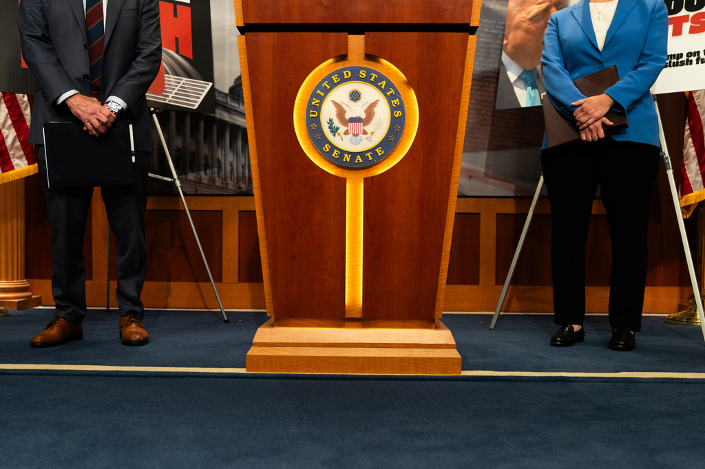 Sen. Mark Kelly, D-Ariz., left, and Sen. Elissa Slotkin, D-Mich., attend a press conference about the introduction of the Drain the Slush Fund Act, Monday, June 1, 2026, in Washington. (AP Photo/Allison Robbert)