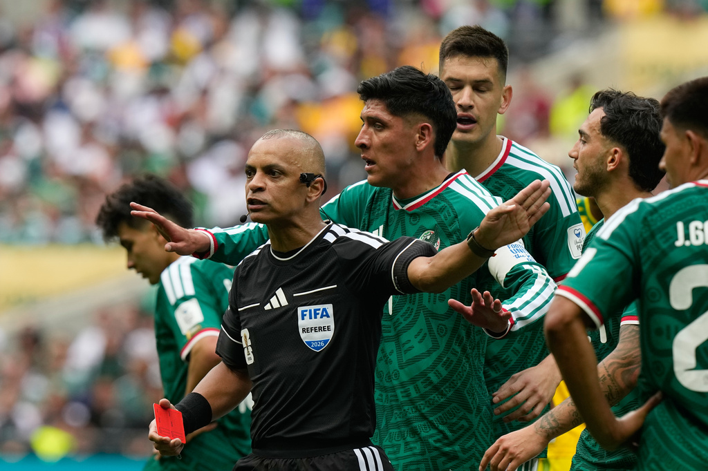 Mexican players complain to referee Wilton Sampaio, of Brazil, after he showed the red card Mexico's Cesar Montes during the World Cup Group A soccer match between Mexico and South Africa in Mexico City, Thursday, June 11, 2026. (AP Photo/Fernando Llano)