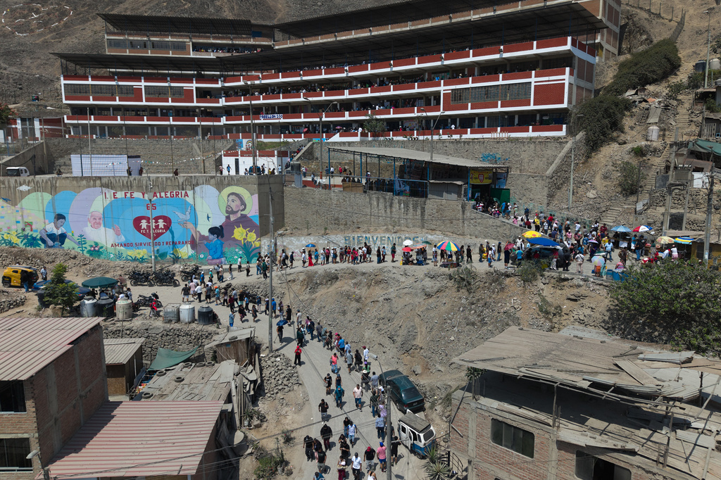 Voters line up outside a polling station during general elections in Lima, Peru, Sunday, April 12, 2026. (AP Photo/Guadalupe Pardo)
