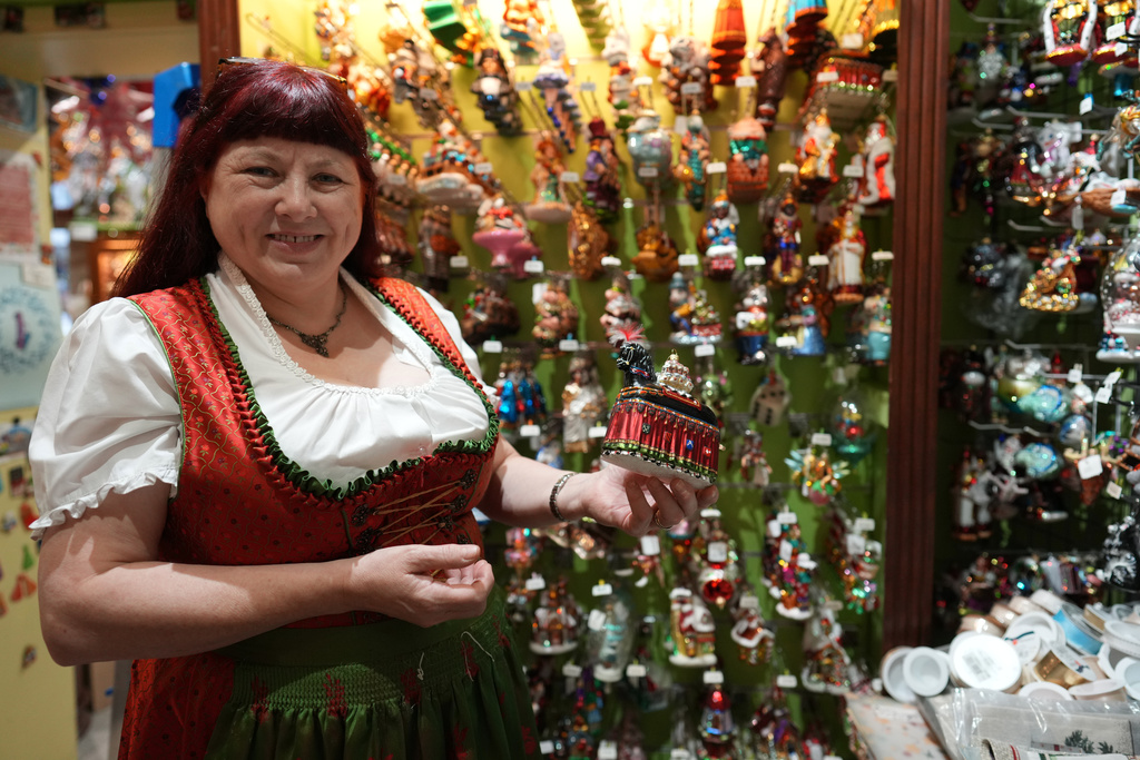Owner of the Christel Dauwe Collection ornaments shop, Christel Dauwe, shows an ornament of the Horse Bayard, a folkloric Belgian event, at her shop in Antwerp, Belgium, Monday, Dec. 8, 2025. (AP Photo/Virginia Mayo)