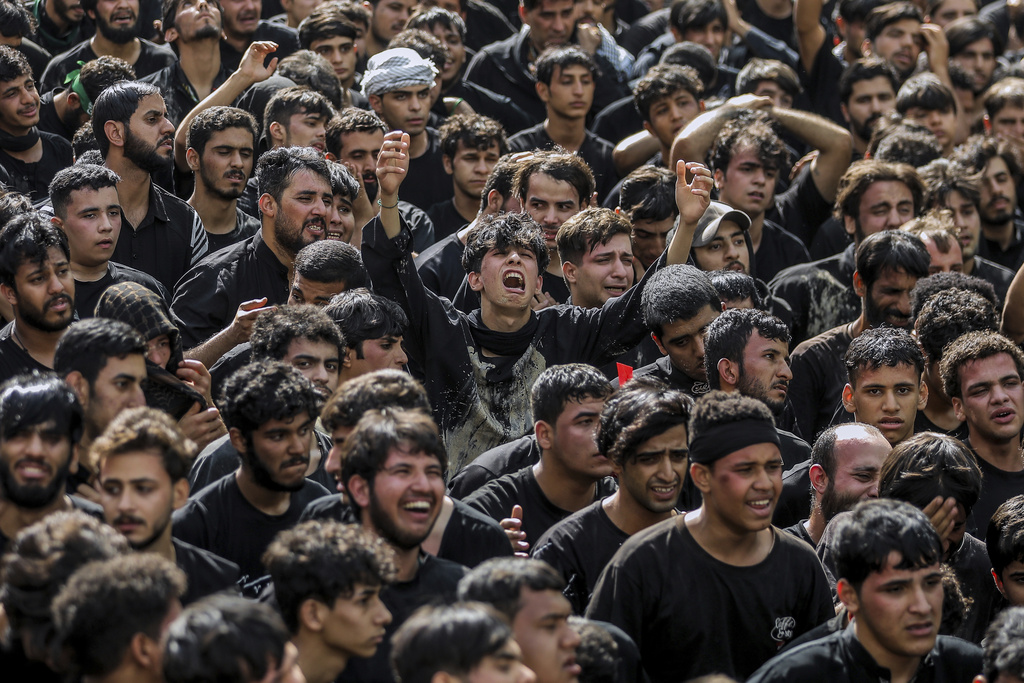 Shiite pilgrims participate in Arbaeen, which marks the end of the 40-day mourning period following Ashoura, in Karbala, Iraq, Thursday, Aug. 14, 2025. (AP Photo/Ammar Khalil)