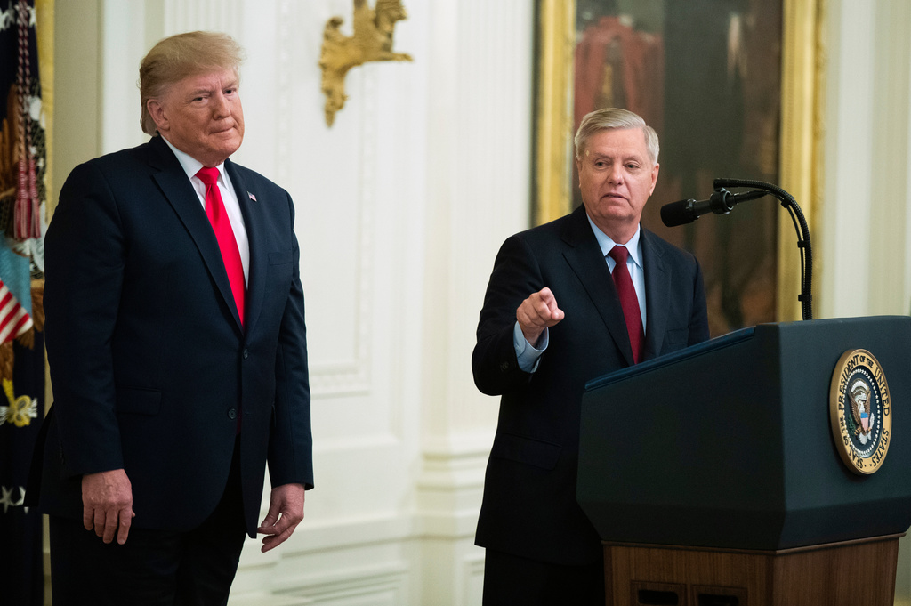 FILE - President Donald Trump listens to Sen. Lindsey Graham, R-S.C., speak during a ceremony in the East Room of the White House, Nov. 6, 2019, in Washington. (AP Photo/Manuel Balce Ceneta, File)